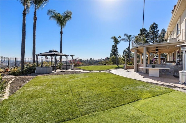 view of yard featuring a gazebo, ceiling fan, and a patio area