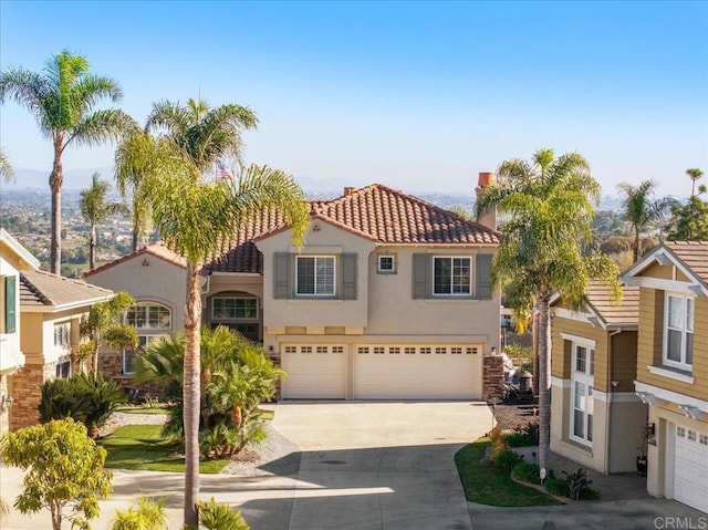 mediterranean / spanish home with a garage