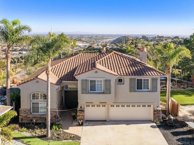 mediterranean / spanish-style house featuring a garage