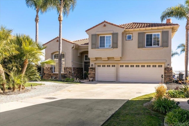 mediterranean / spanish-style house with a garage