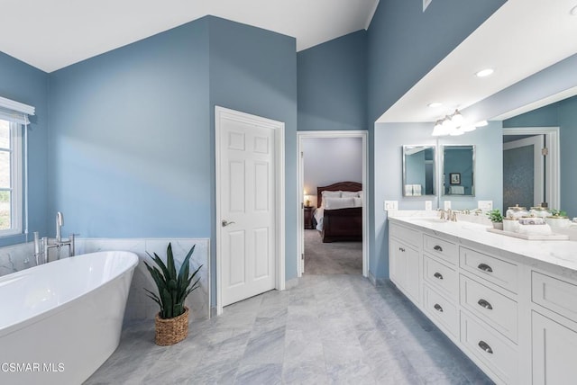 bathroom with vanity, a tub, and a chandelier