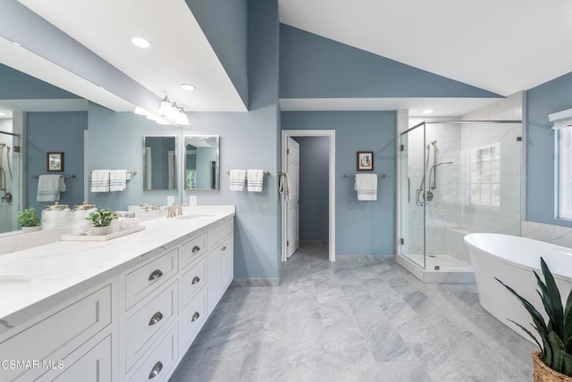 bathroom with lofted ceiling, vanity, and independent shower and bath