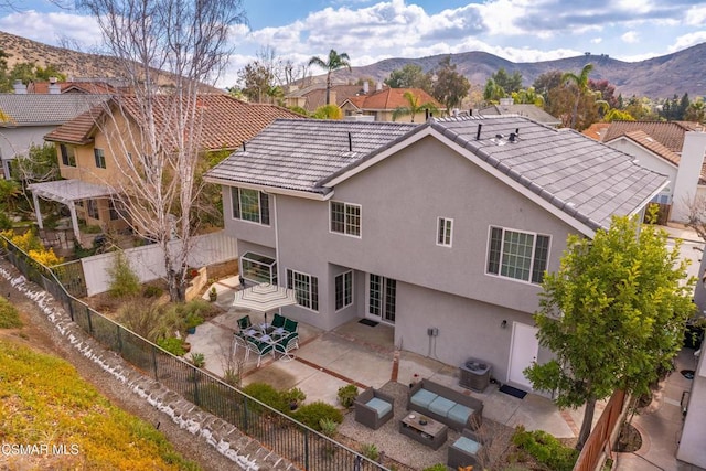 back of property featuring an outdoor living space, a mountain view, cooling unit, and a patio area