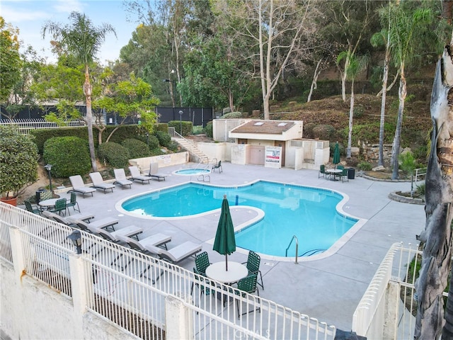 view of pool with a community hot tub and a patio area