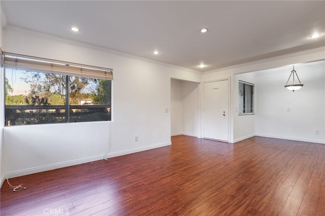 spare room with crown molding and dark hardwood / wood-style floors