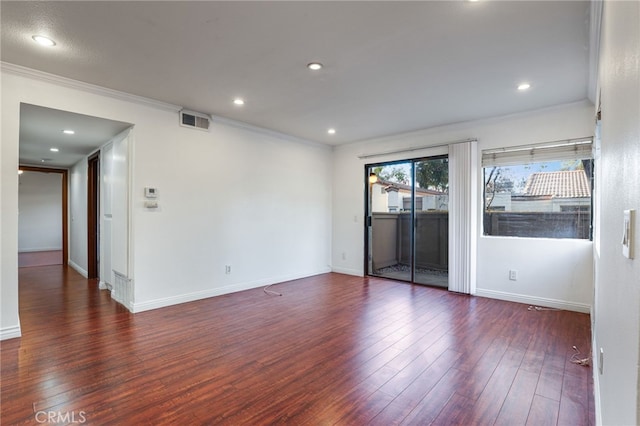 empty room with crown molding and dark wood-type flooring