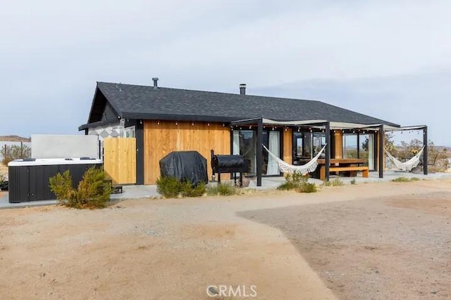 view of front of property with a jacuzzi