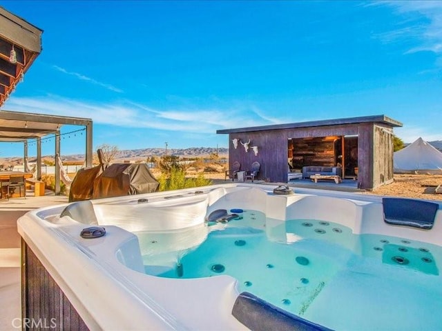 view of pool with a hot tub