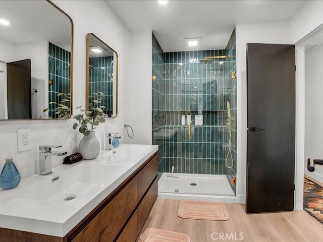 bathroom featuring vanity, wood-type flooring, and an enclosed shower