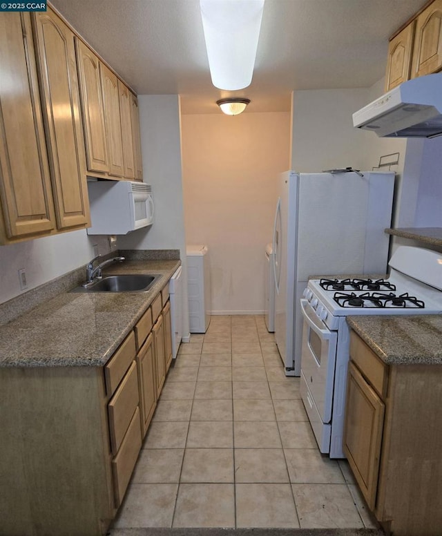 kitchen with white appliances, sink, and light tile patterned floors