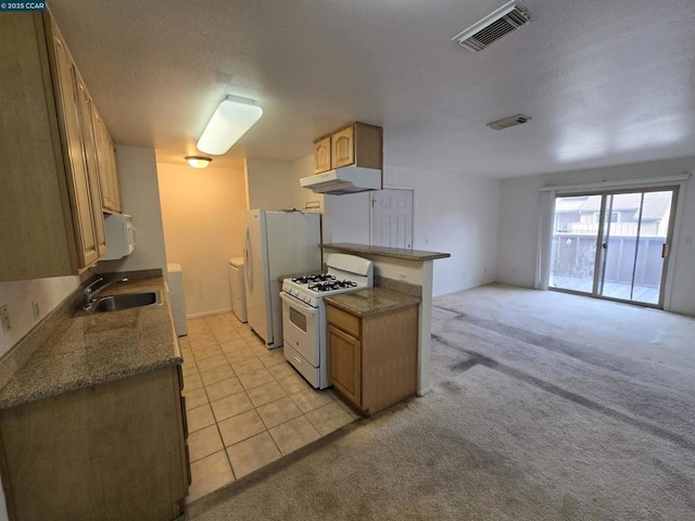 kitchen featuring sink, white appliances, washer and dryer, kitchen peninsula, and light colored carpet