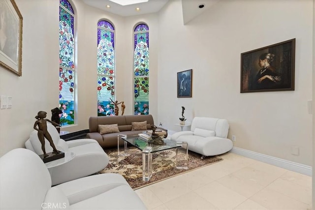 living room featuring light tile patterned flooring and a skylight