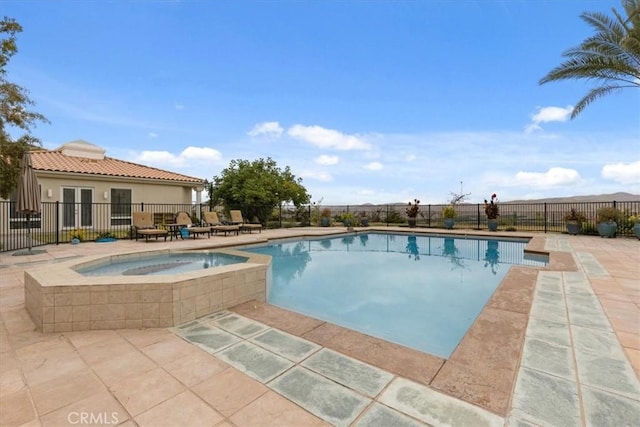 view of pool featuring an in ground hot tub and a patio