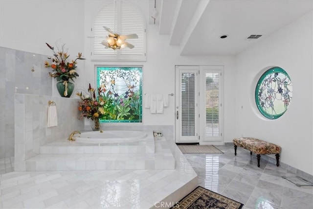 bathroom featuring tiled tub