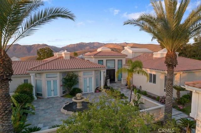 rear view of house with a mountain view