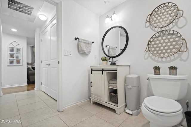 bathroom featuring vanity, tile patterned floors, and toilet