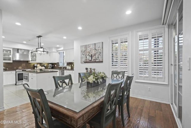 dining space with light hardwood / wood-style flooring and a chandelier