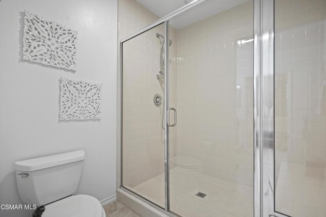 bathroom featuring walk in shower and toilet