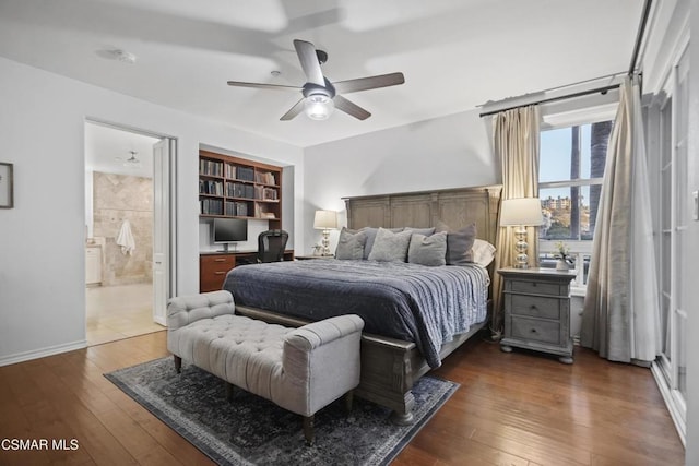 bedroom featuring ceiling fan, ensuite bathroom, and dark hardwood / wood-style floors