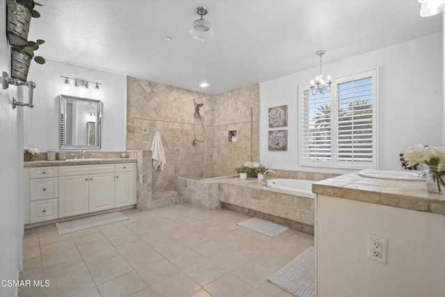 bathroom with tile patterned flooring, vanity, independent shower and bath, and a chandelier