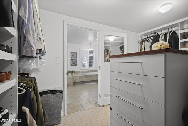 spacious closet featuring light tile patterned floors