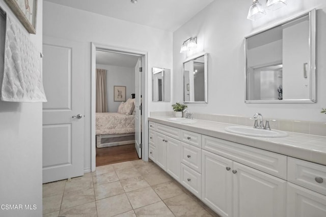 bathroom with tile patterned floors and vanity