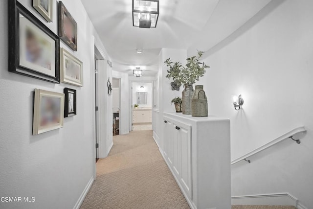 hall featuring light colored carpet