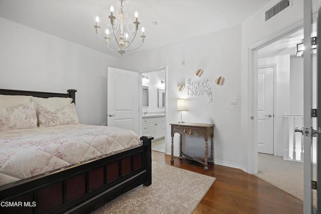 bedroom featuring dark hardwood / wood-style flooring and ensuite bath