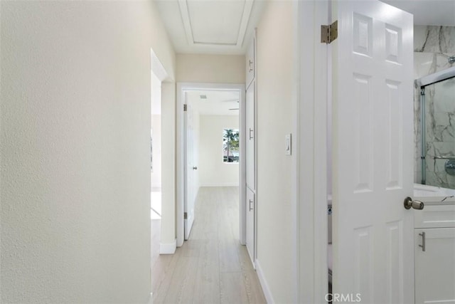 corridor with light hardwood / wood-style flooring