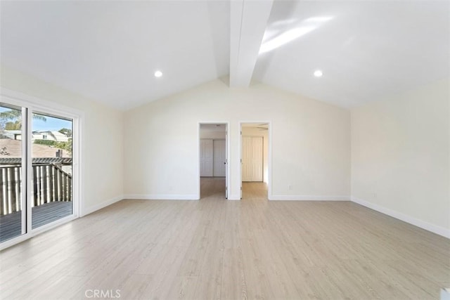 spare room featuring lofted ceiling with beams and light hardwood / wood-style floors