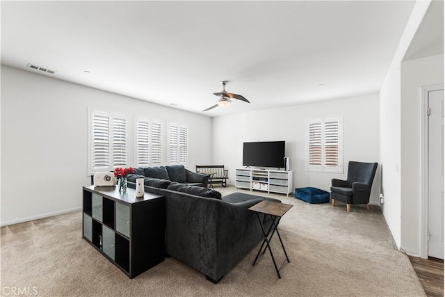 carpeted living room featuring ceiling fan