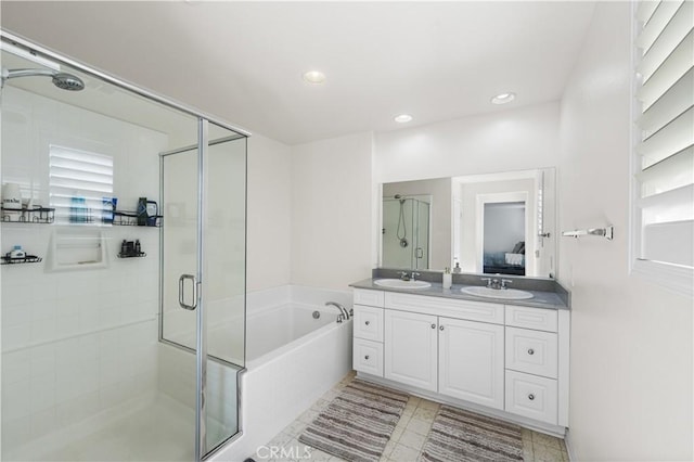 bathroom with vanity and independent shower and bath