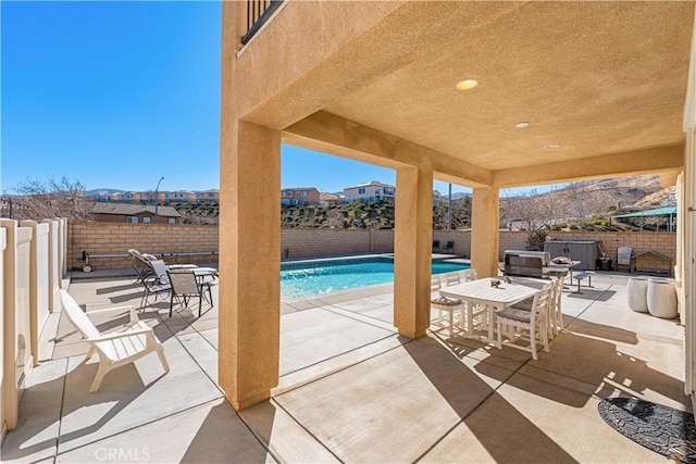 view of patio / terrace with a fenced in pool