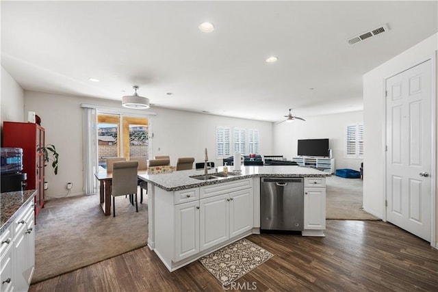 kitchen featuring a center island with sink, sink, stainless steel dishwasher, and white cabinets