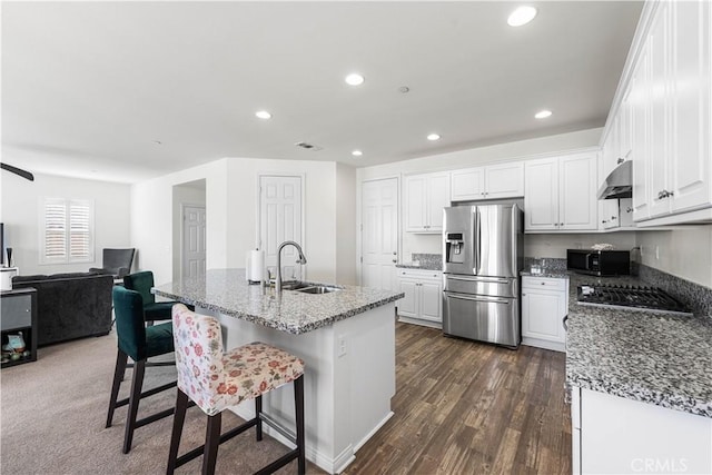 kitchen with white cabinetry, sink, dark stone countertops, and black appliances