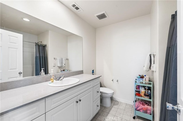 bathroom featuring vanity, walk in shower, and toilet