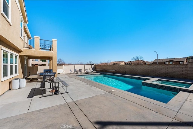 view of swimming pool with a patio area and an in ground hot tub