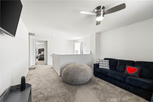 living room with light colored carpet and ceiling fan