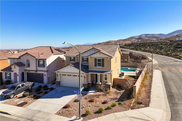 view of front of property featuring a mountain view, a garage, and solar panels