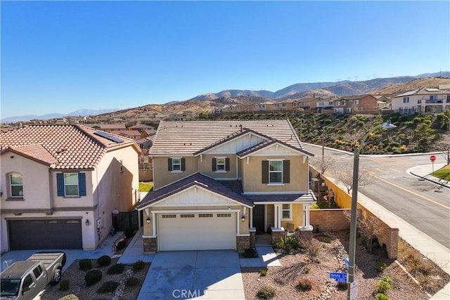 view of front of property with a garage and a mountain view