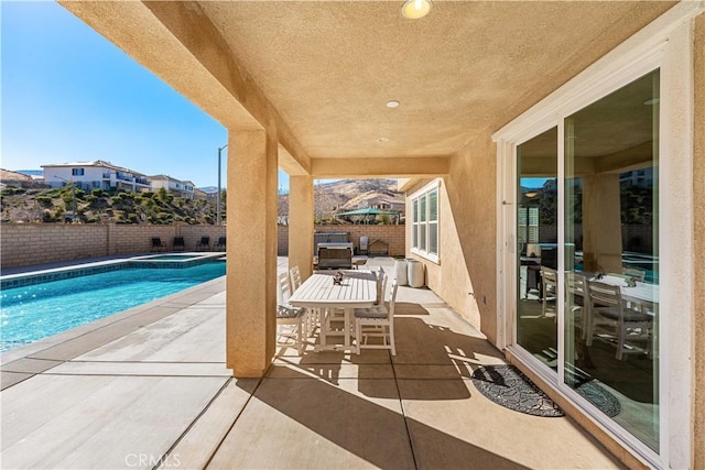 view of pool featuring a patio and an in ground hot tub