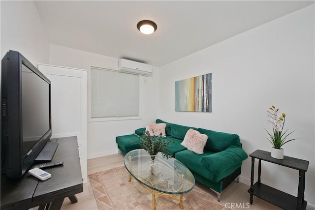 living room with a wall mounted AC and light hardwood / wood-style flooring