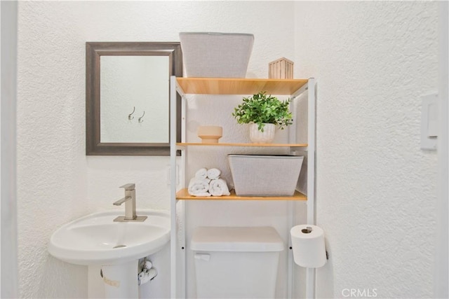 bathroom featuring sink and toilet