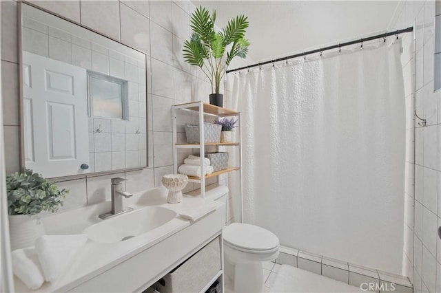 bathroom featuring tile walls, tile patterned flooring, vanity, toilet, and a shower with curtain