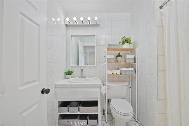 bathroom featuring a shower with curtain, vanity, toilet, and tile walls