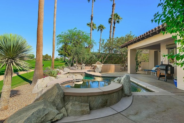 view of pool featuring a grill, a patio, and an in ground hot tub