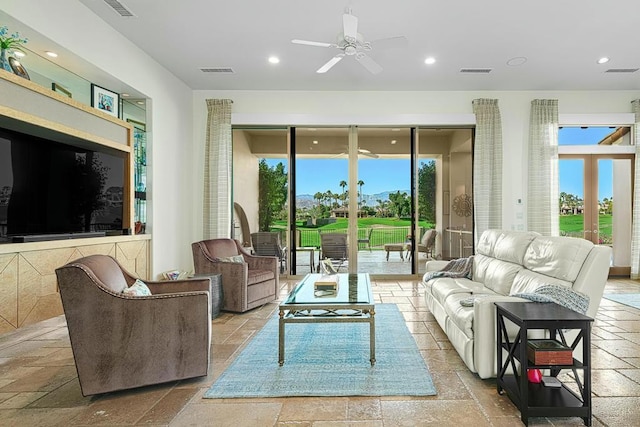 living room with ceiling fan and plenty of natural light