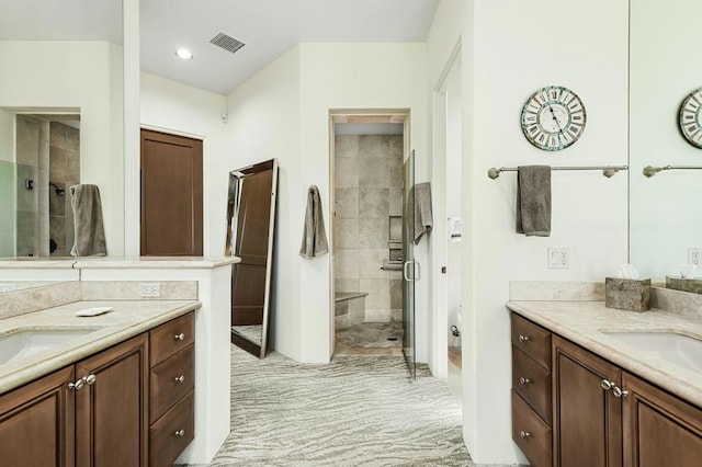 bathroom featuring vanity and an enclosed shower