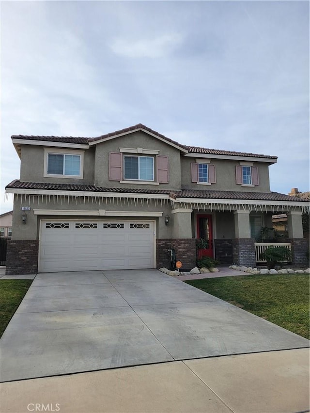 view of front of home with a garage and a front lawn