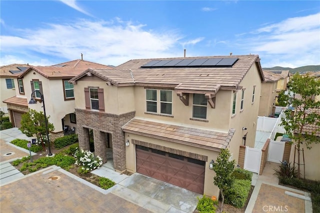 multi unit property featuring a garage and solar panels